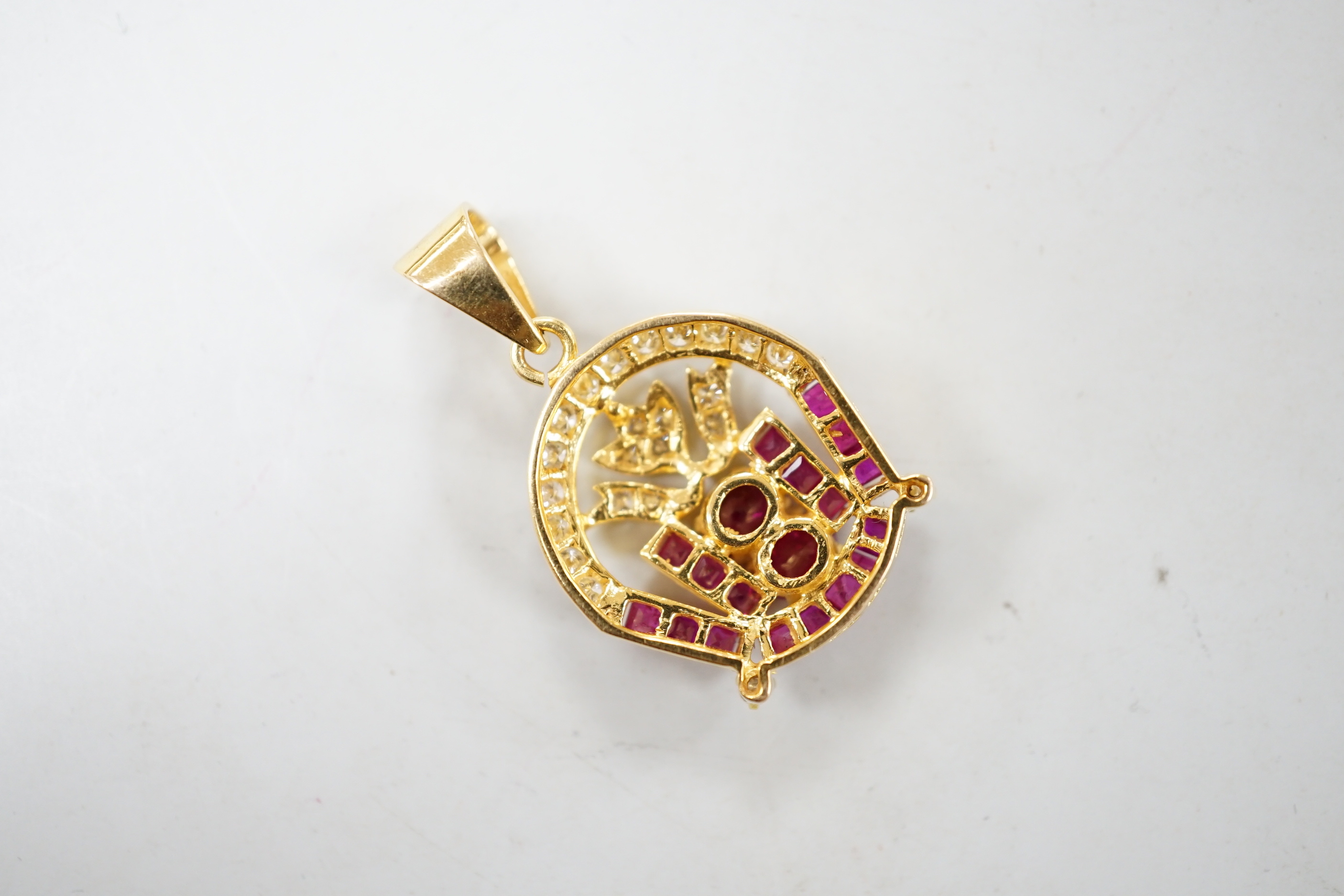 A modern 18k yellow metal, diamond chip, round and square cut ruby cluster set drop pendant, overall 32mm, gross weight 6.4 grams.